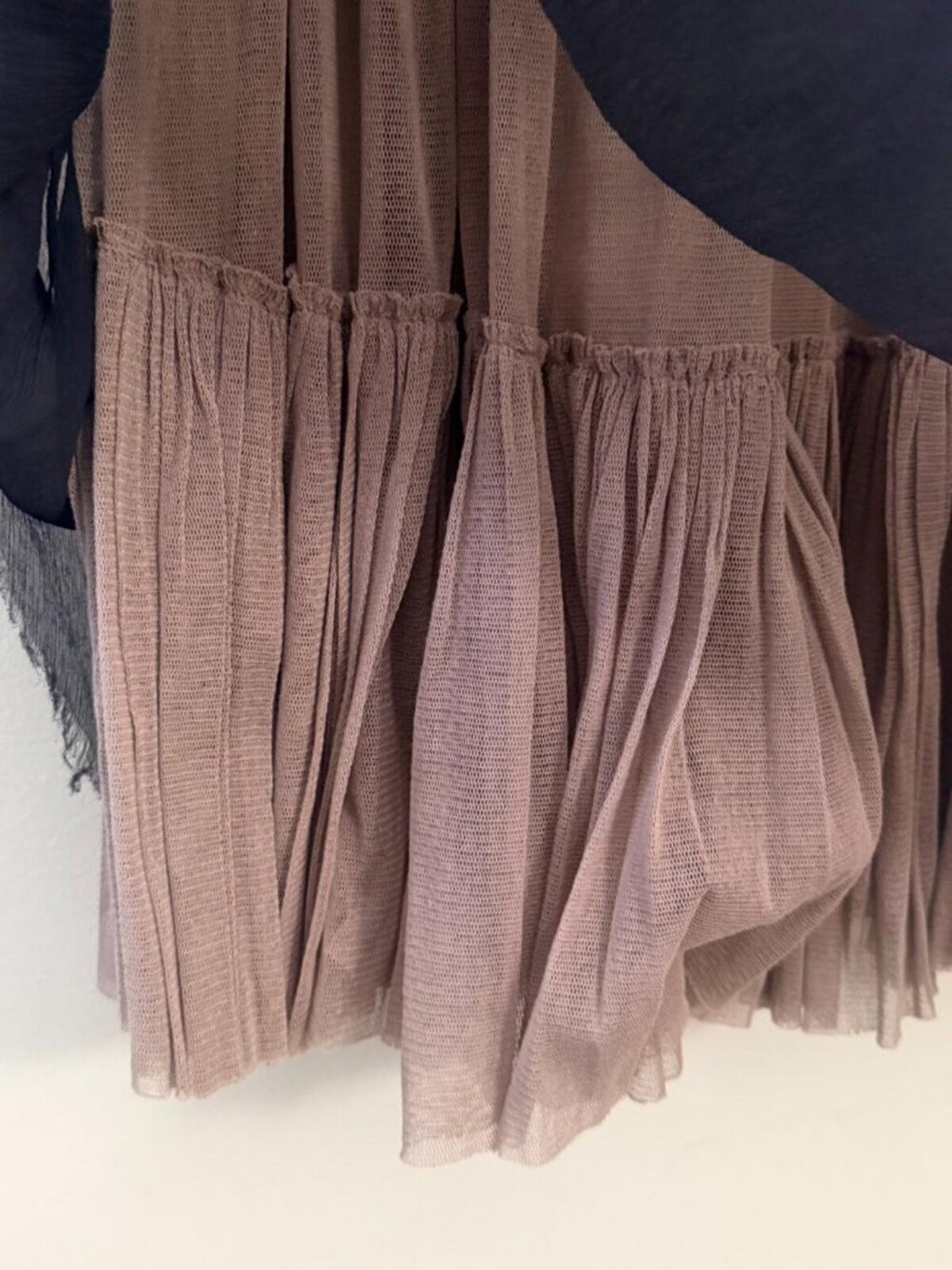 Close-up view of MARTIN GRANT FRENCH SILK RAW HEM LAYERED CIRCLE SKIRT S showcasing pleated tan silk layers.