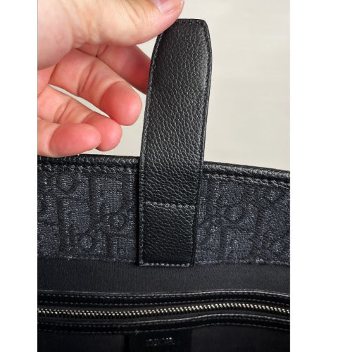 Interior view of CHRISTIAN DIOR KIM JONES BLACK OBLIQUE MONOGRAM TOTE BAG featuring handle detail.