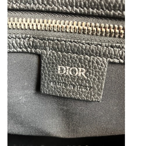 Interior label of the CHRISTIAN DIOR KIM JONES BLACK OBLIQUE MONOGRAM TOTE BAG showing 'DIOR MADE IN ITALY' tag.