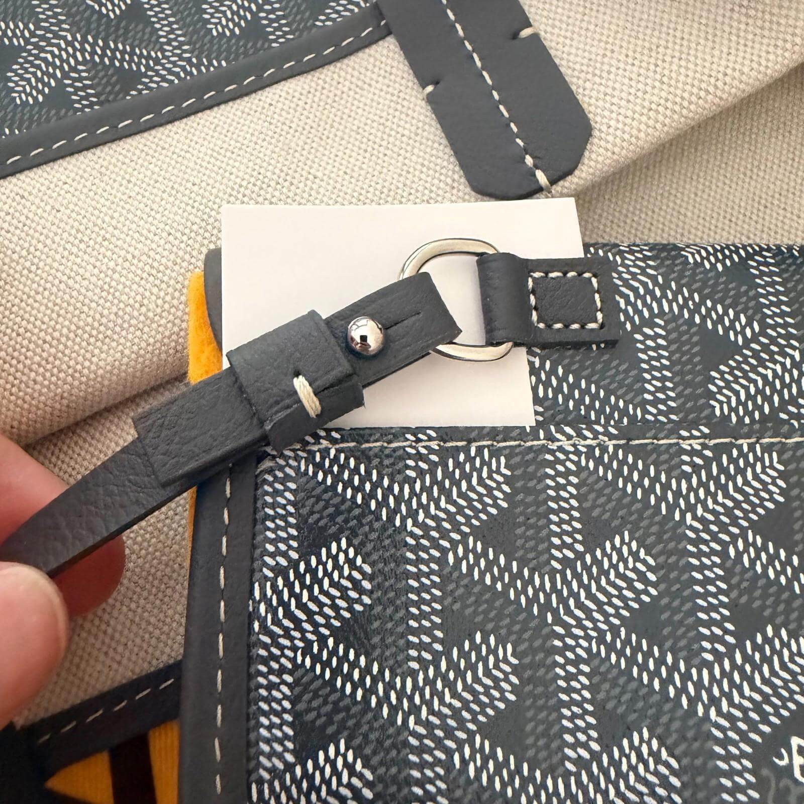 Goyard St. Louis bag GM- Goyardine showing interior straps and care tags attached.