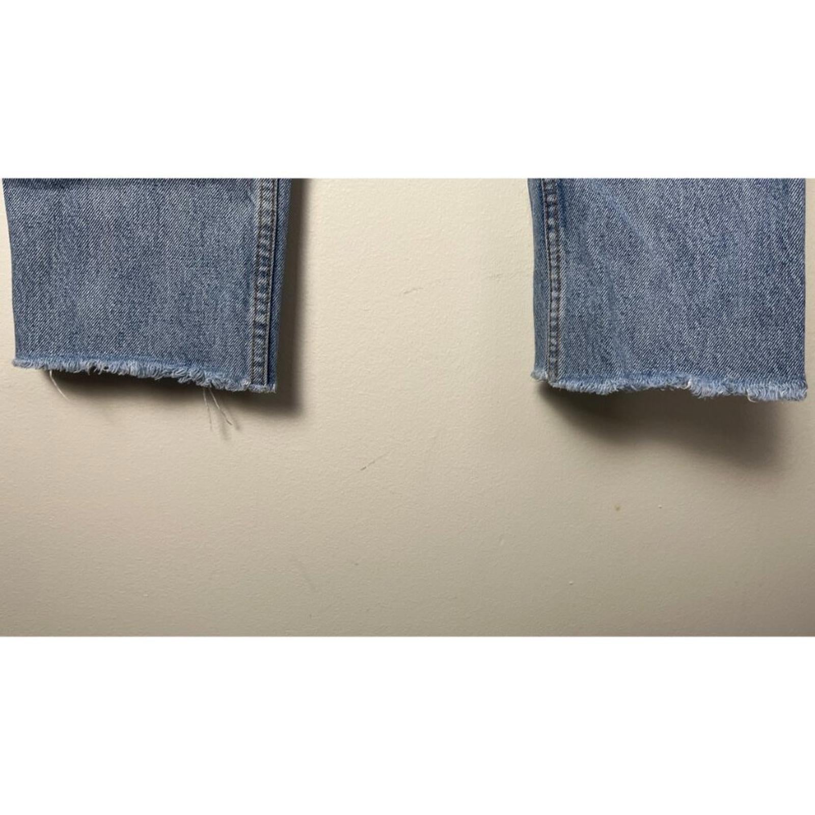 REDONE LEVIS VINTAGE DENIM JEANS cropped hem detail showcasing worn edges and fabric in blue denim.