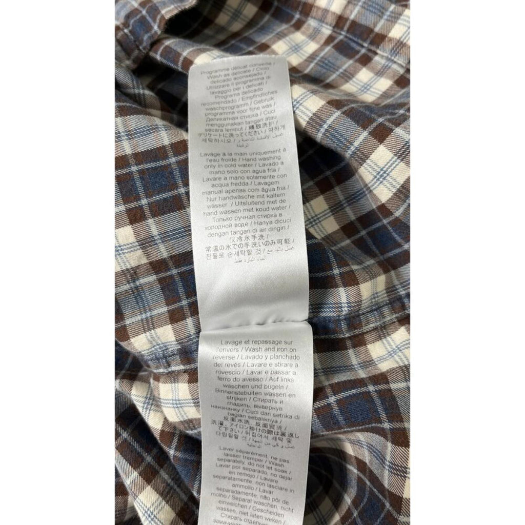 KENZO PARIS X NIGO 2 TONE PLAID OVERSIZED SHIRT care label on plaid fabric, featuring washing instructions and fabric details.