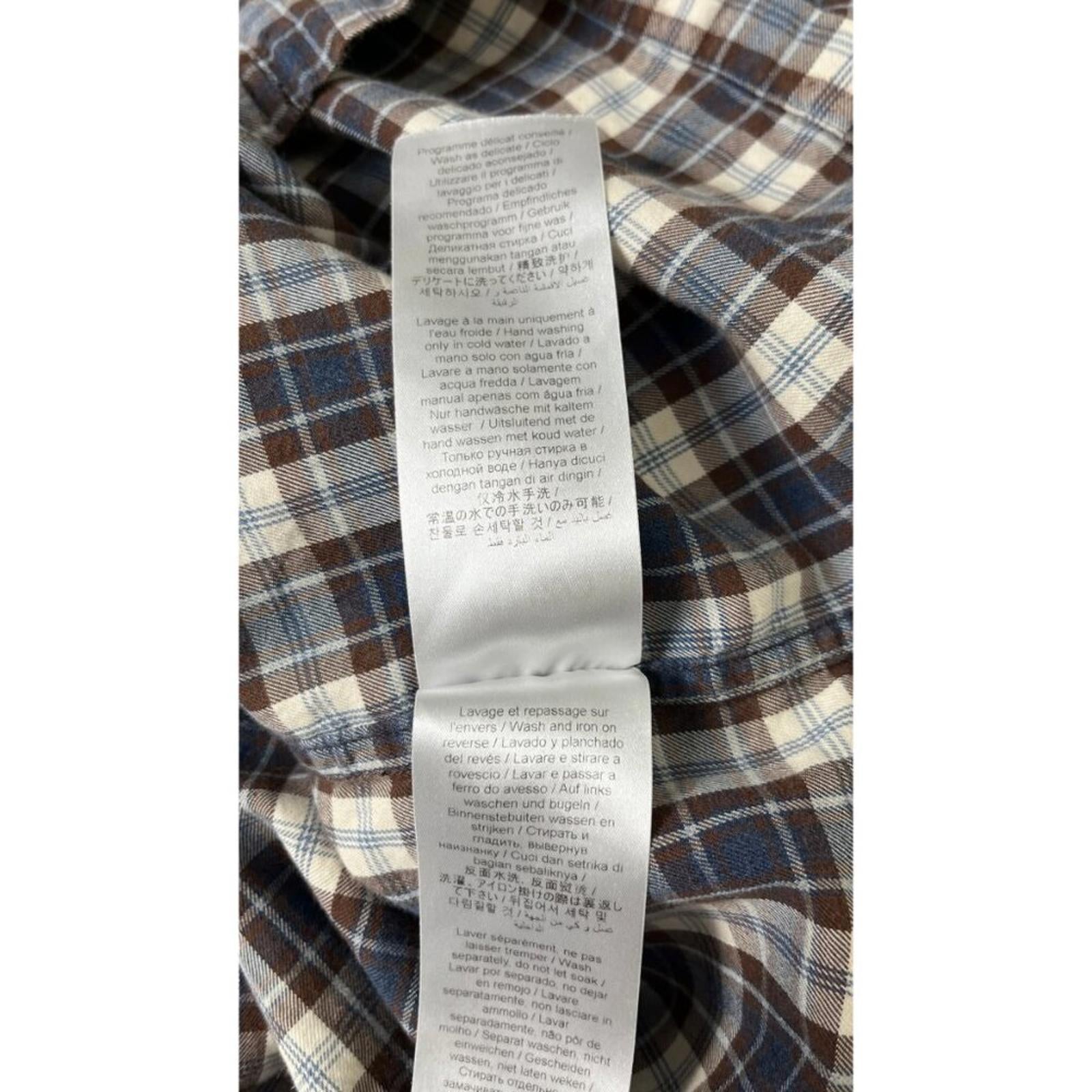 KENZO PARIS X NIGO 2 TONE PLAID OVERSIZED SHIRT care label on plaid fabric, featuring washing instructions and fabric details.