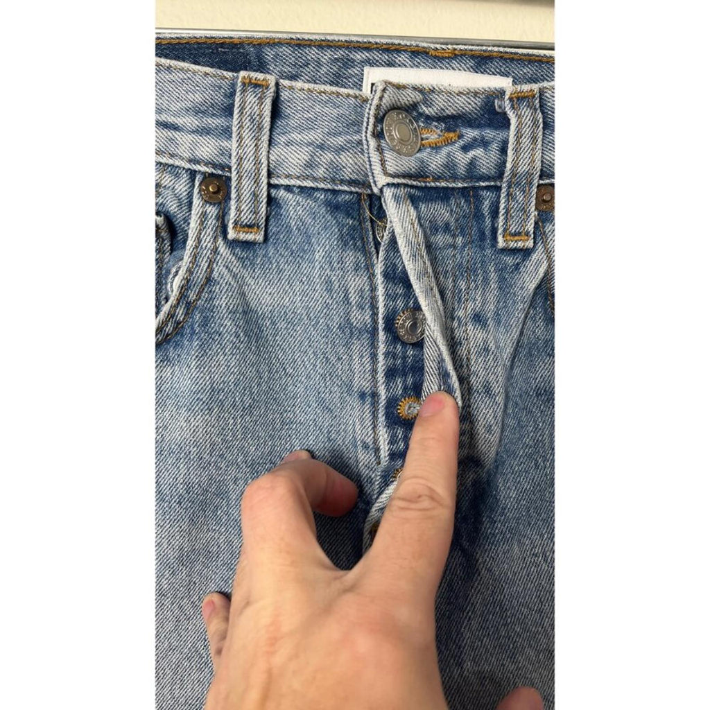 REDONE LEVIS VINTAGE DENIM JEANS close-up showing front button and zipper area highlighting quality and wear.