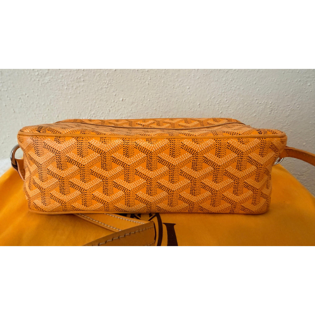 GOYARD YELLOW CAP VERT CROSSBODY BAG showcasing rich yellow Goyardine pattern and adjustable strap on a vibrant background.