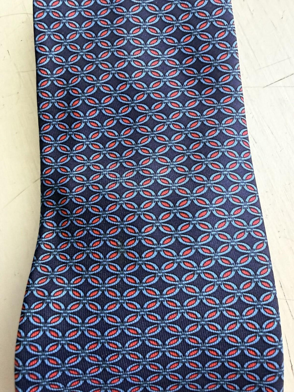 HERMES PARIS GEOMETRIC PRINT NECK TIE featuring a distinctive geometric pattern in red and blue.