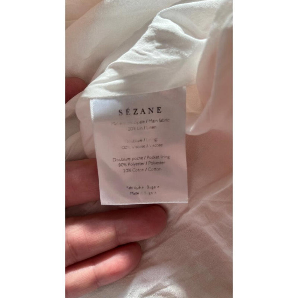 SEZANE GINGHAM PLAID SHORTS 38 fabric care label showing material composition and care instructions.