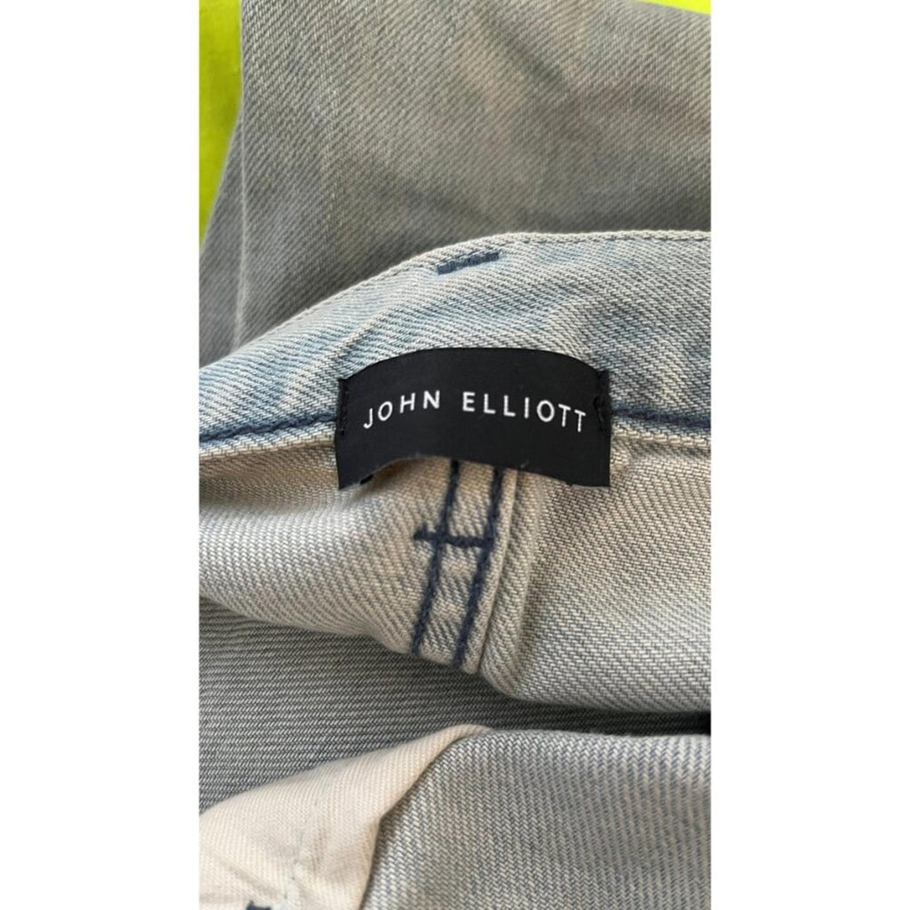 Close-up of the label on JOHN ELLIOTT THE CAST 2 SPRING DIRTY JEANS, showing the brand name clearly.