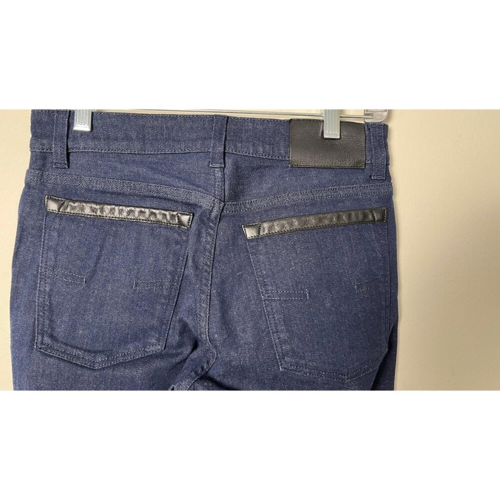 Back view of SALVATORE FERRAGAMO DARK NAVY CROPPED DENIM JEANS showing pockets and details.