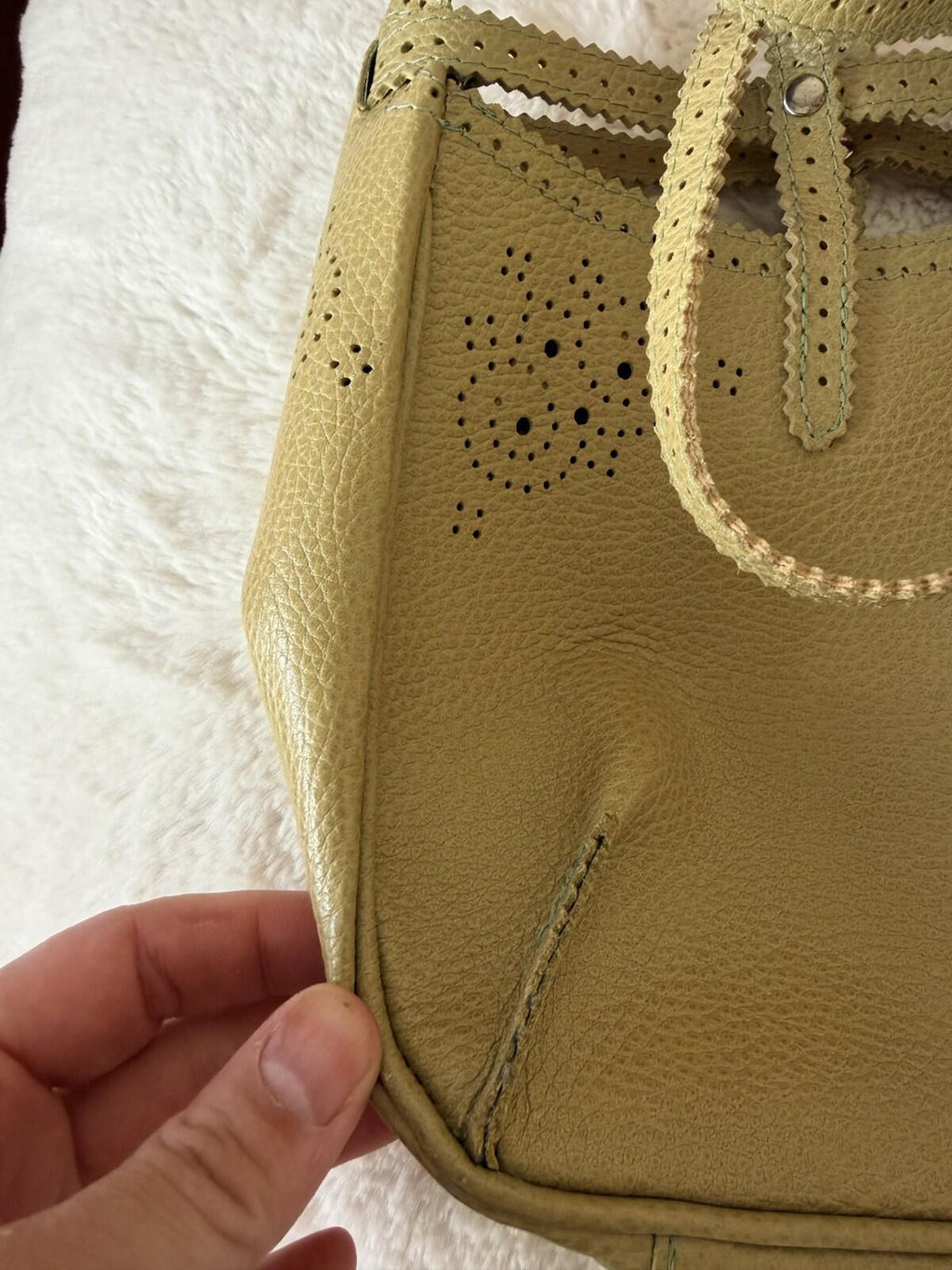 Close-up of the JAMIN PUECH DELICATE DETAIL HANDBAG showcasing intricate lace perforation and vibrant chartreuse color.
