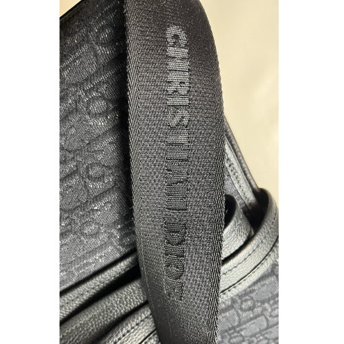 CHRISTIAN DIOR KIM JONES BLACK OBLIQUE MONOGRAM TOTE BAG strap detail showcasing the embossed logo.