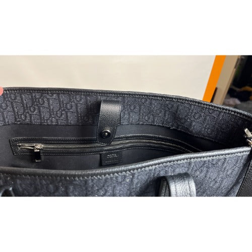 Interior view of the CHRISTIAN DIOR KIM JONES BLACK OBLIQUE MONOGRAM TOTE BAG showing black monogrammed lining and zip pocket.