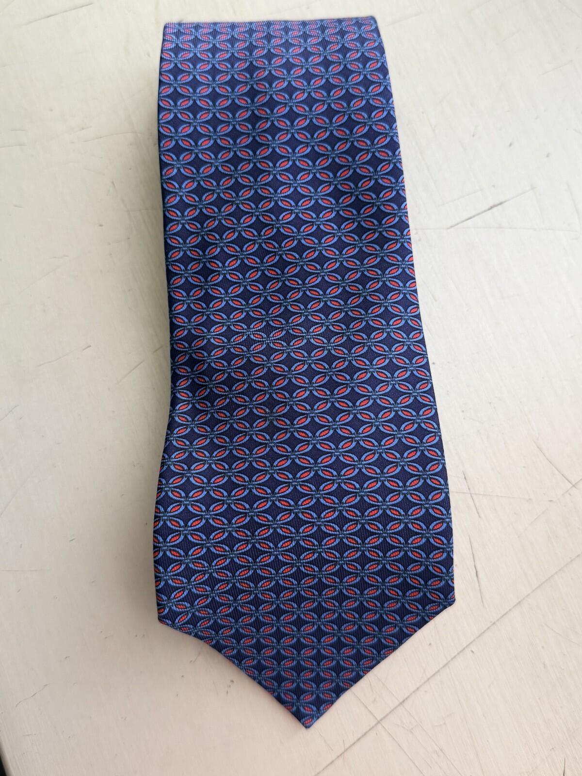 HERMES PARIS GEOMETRIC PRINT NECK TIE featuring a blue background with geometric patterns in red.