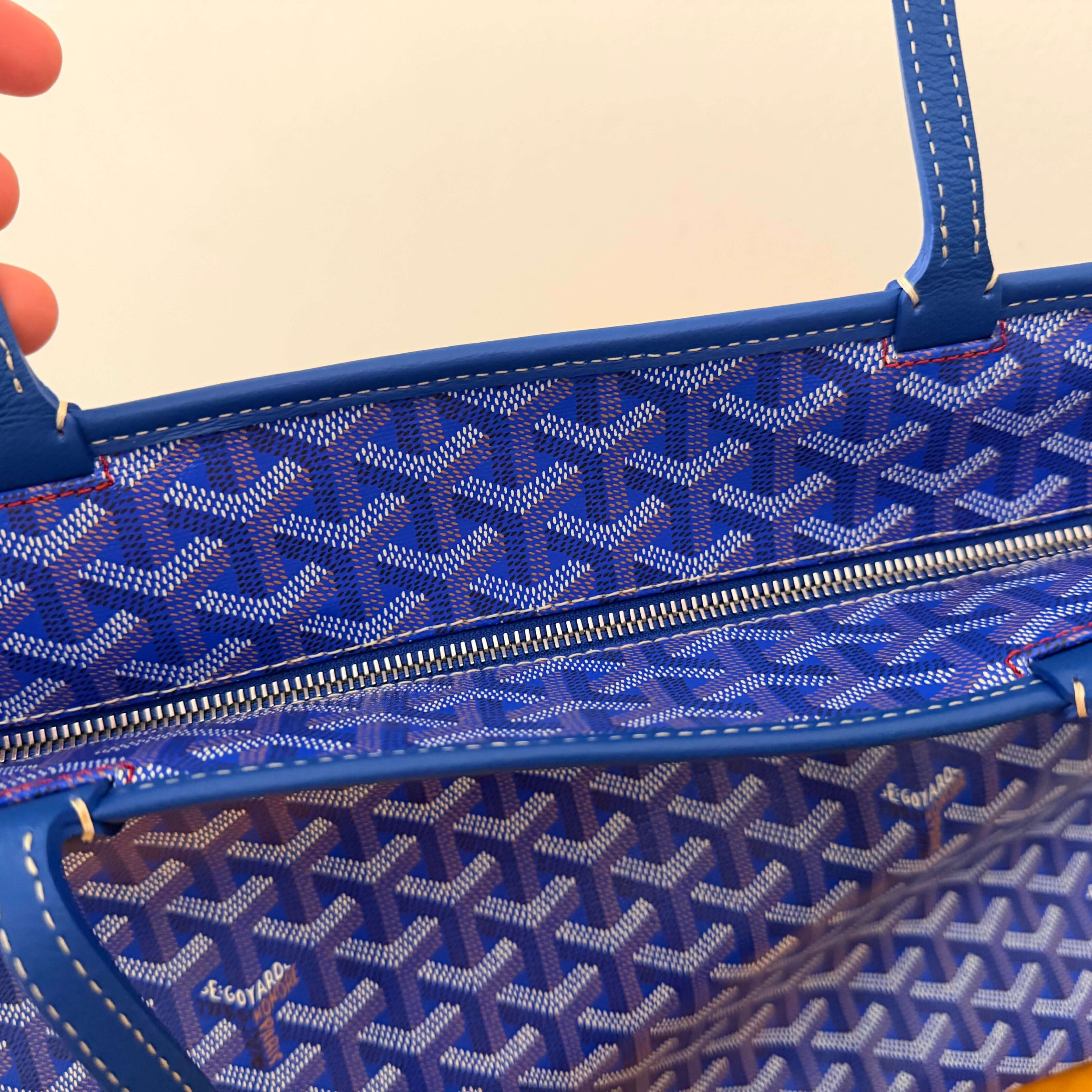 Interior view of the Goyard Artois MM Tote Bag- Goyardine showing blue patterned lining and zipper pocket.