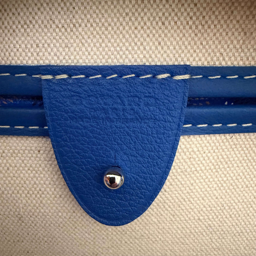 Goyard Artois MM Tote Bag- Goyardine detail featuring blue leather tag and stitching.