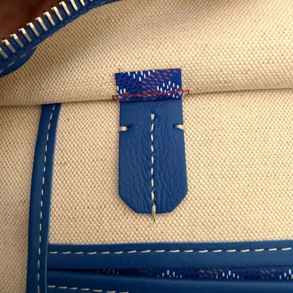 Interior close-up showing the blue leather tag and stitching of the Goyard Artois MM Tote Bag- Goyardine.
