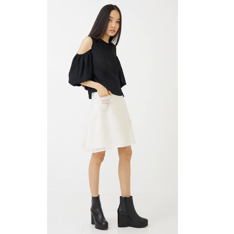 MORGANE LE FAY STELLA BRIDAL MINI KNIT SEQUIN SKIRT styled with a black cold-shoulder top and black platform ankle boots.