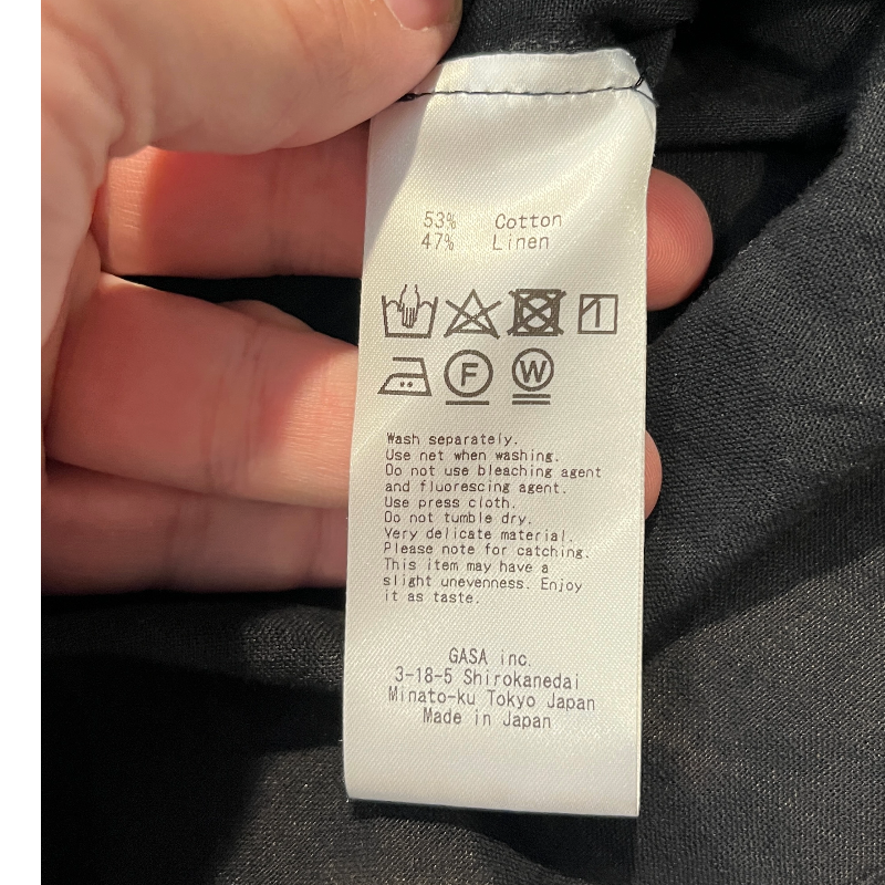 Care label for NATIVE VILLAGE LINEN BOHO SHEER BLOUSE, detailing fabric content and washing instructions.