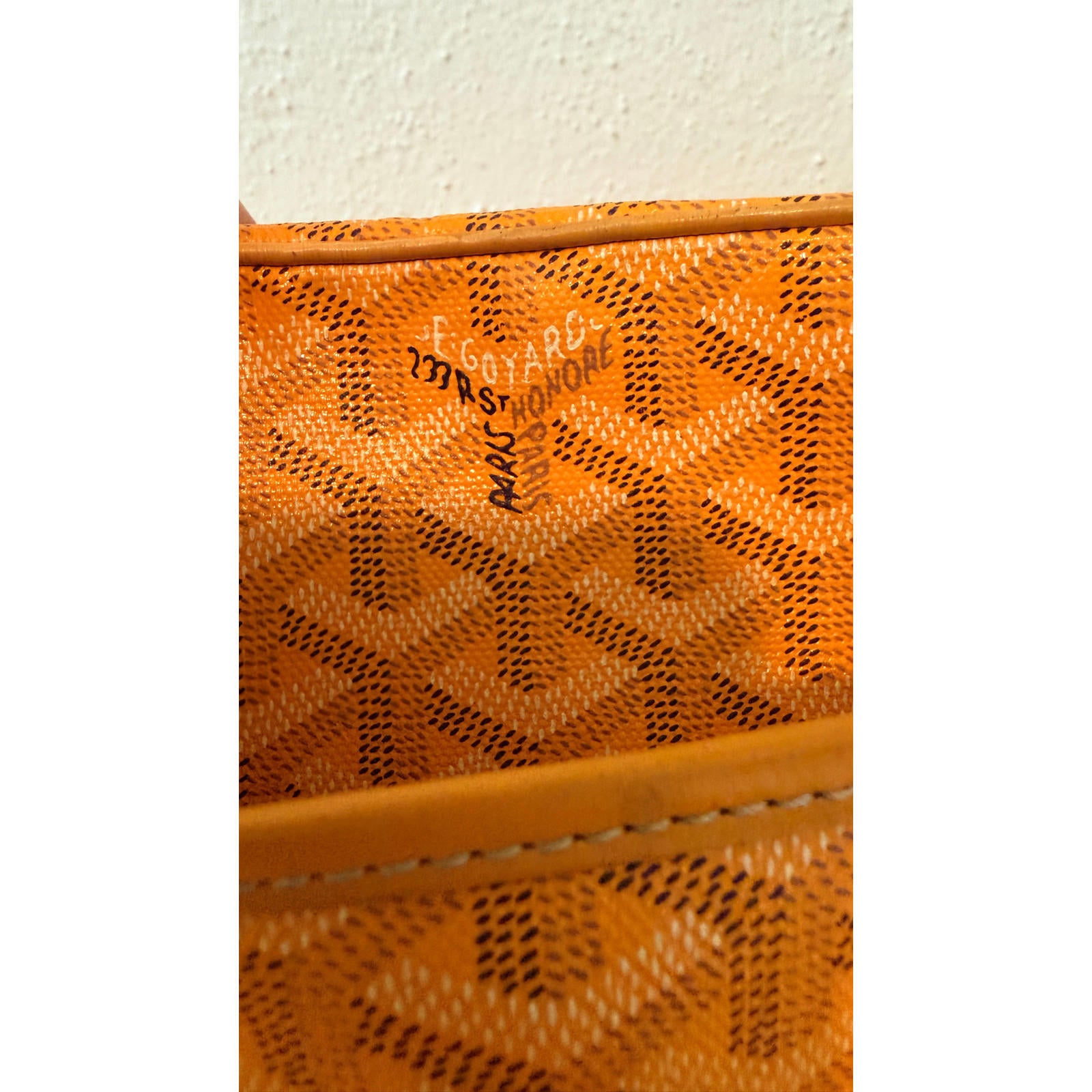Interior view of authentic Goyard yellow Cap Vert crossbody bag showcasing Goyardine pattern and hardware details.