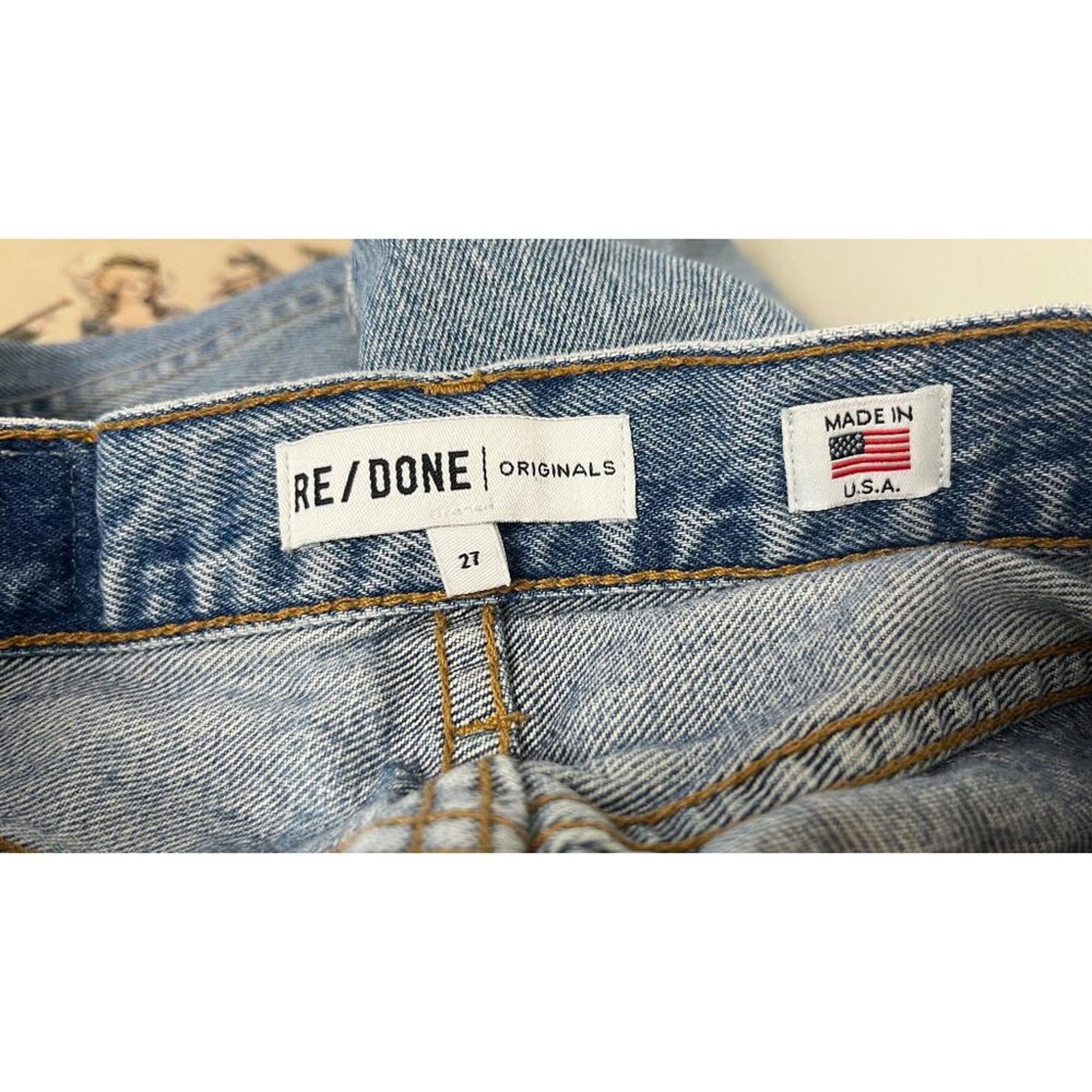 REDONE LEVIS VINTAGE DENIM JEANS tag showing size 27 and made in USA details on the inside of the jeans.