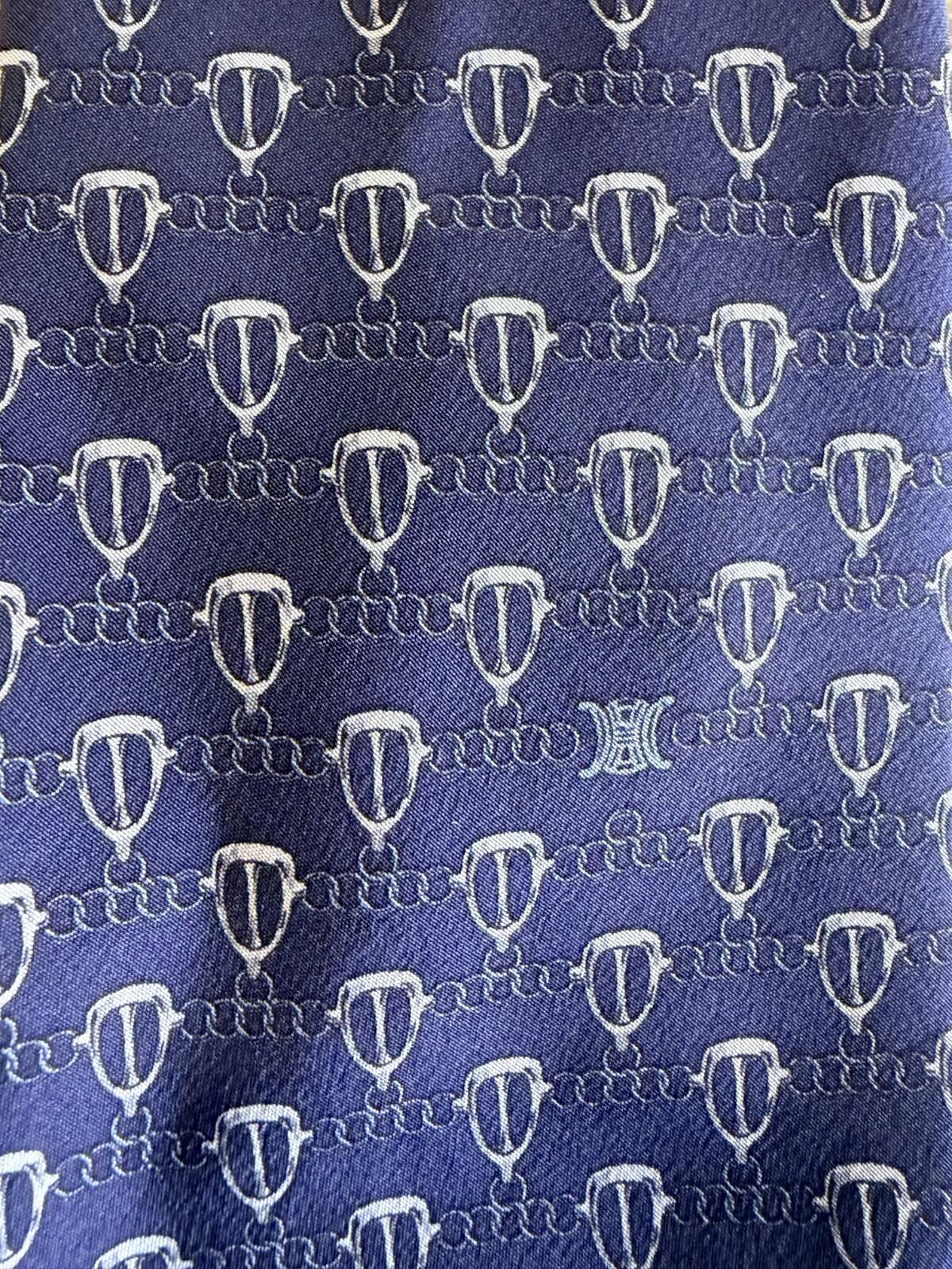 CELINE GEOMETRIC LOGO PRINT NECK TIE fabric pattern featuring a unique geometric design on a rich blue background.