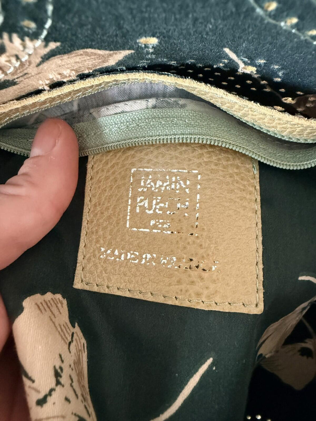 Close-up of the label inside the JAMIN PUECH DELICATE DETAIL HANDBAG showcasing brand details and craftsmanship.
