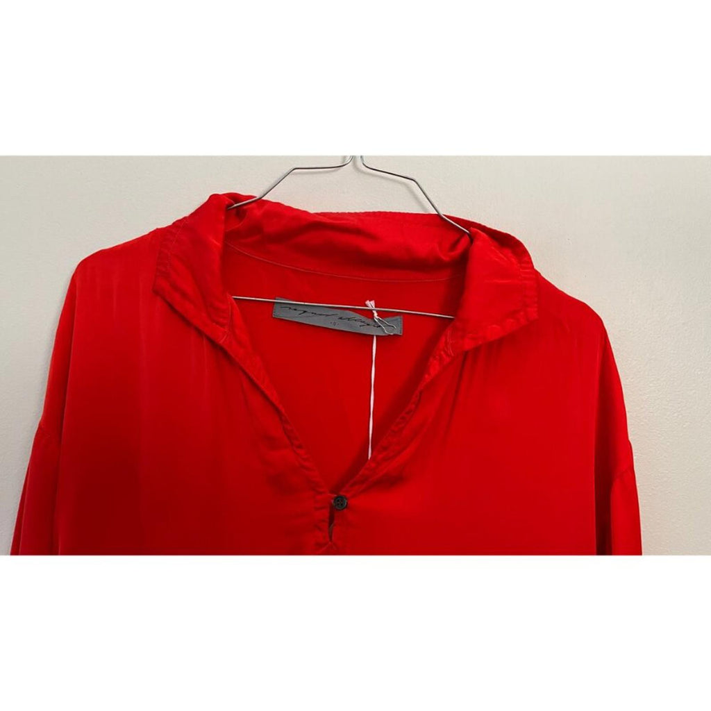 RAQUEL ALLEGRA RED GHOST RANCH MATTE RAYON SATIN DRESS close-up of collar and tag, showing vibrant red fabric.