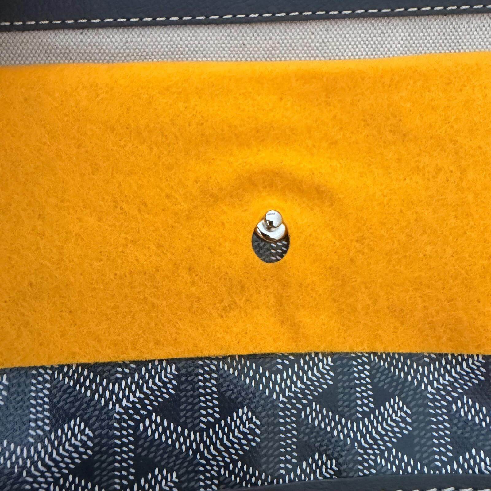 Close-up of the interior straps of an authentic Goyard St. Louis bag GM- Goyardine with felt pouch.
